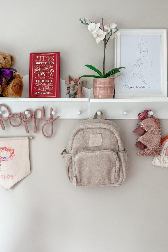 Children's Ava teddy fleece backpack sand beige hanging on a hook 