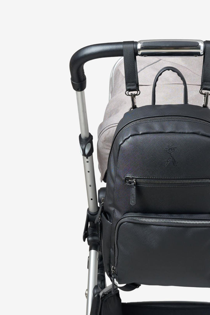 Bloom vegan leather changing backpack clipped to a pram with pram clips