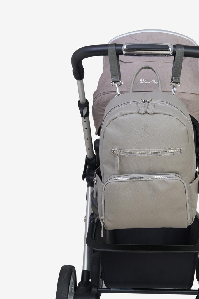 Bloom grey vegan leather baby changing backpack hung on pram with pram clips 