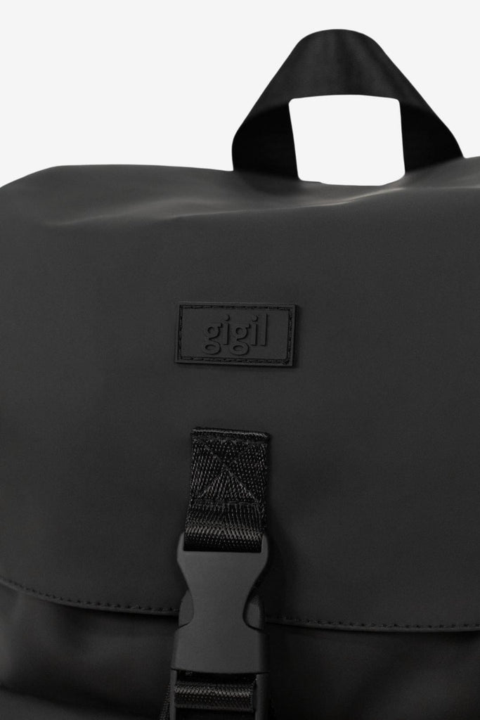 Rubber branded logo on the front of the Nova - Charcoal Black Changing Backpack.