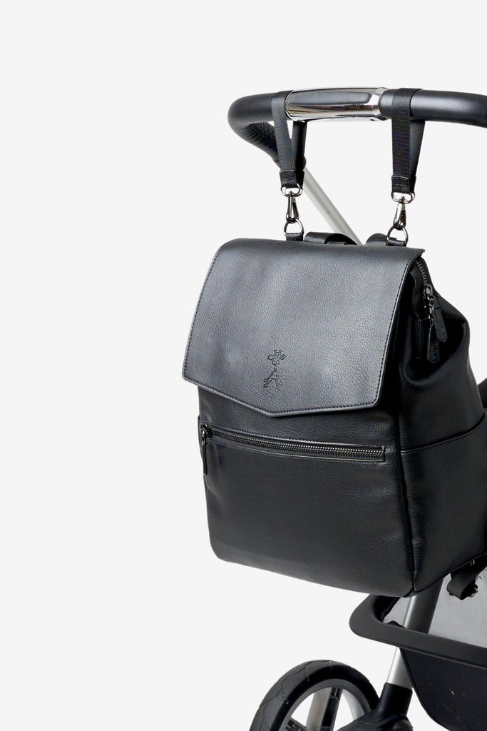 Vegan leather diaper backpack clipped to pram with matching pram clips 