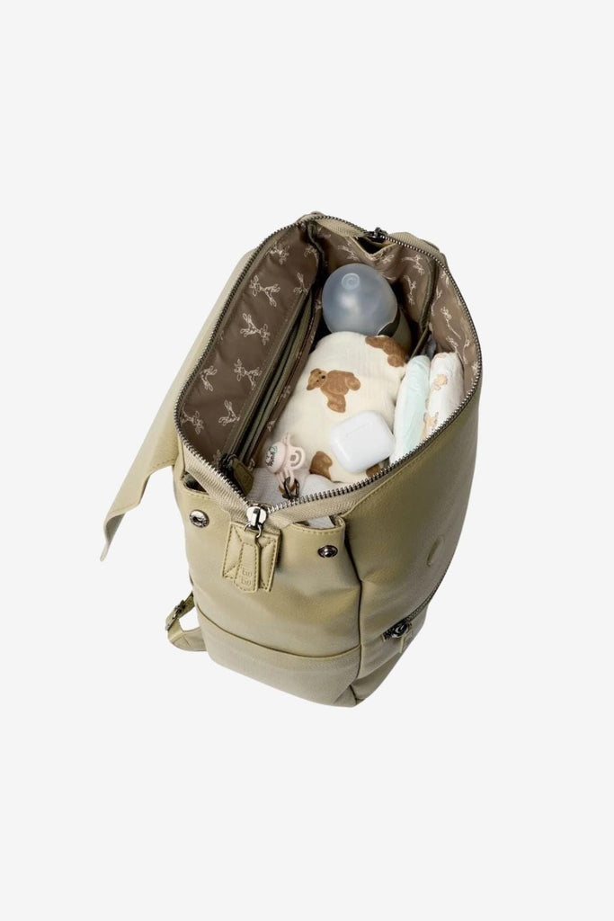 Olive green vegan leather changing backpack with matching giraffe lining filled with baby essentials 