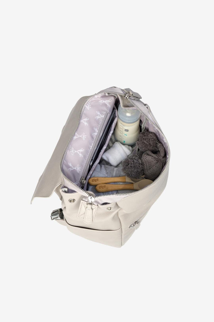 Vegan leather diaper backpack filled with baby essentials and matching grey giraffe lining 