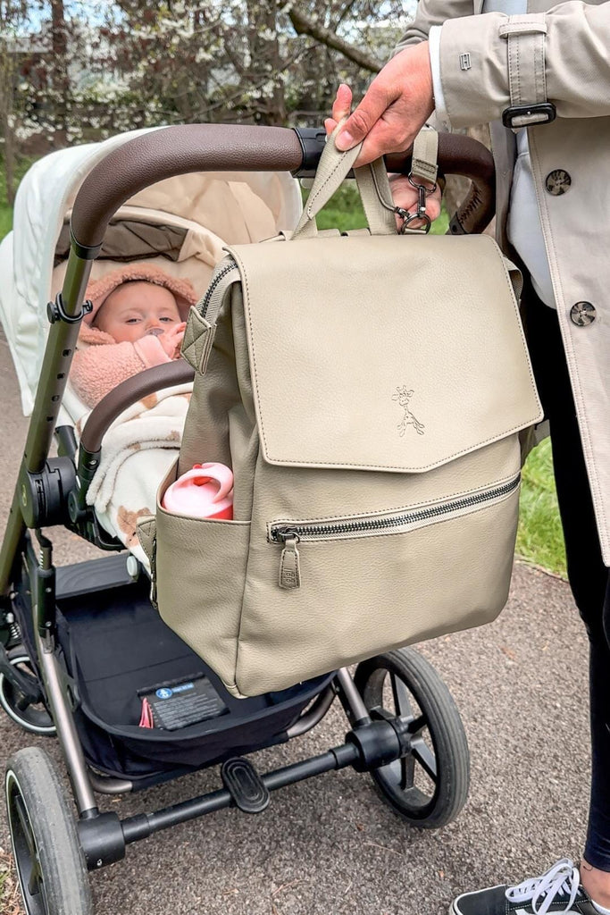Vegan leather diaper backpack clipped to pram with matching pram clips 
