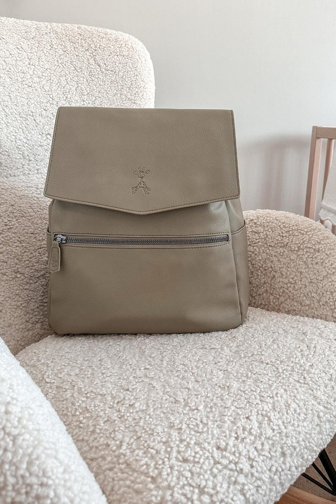 Vegan leather baby changing backpack on nursery chair 