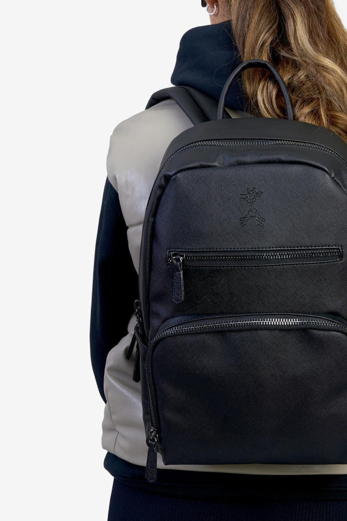 Mum wearing the bloom black vegan leather changing backpack 