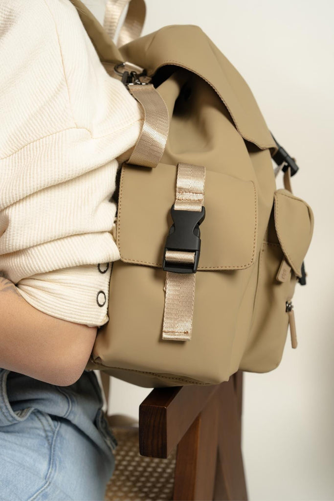 Plastic clip closure/fastener on the Nova - Desert Sand Changing Backpack.