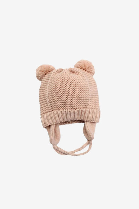 Pink knit baby bobble hat on white background