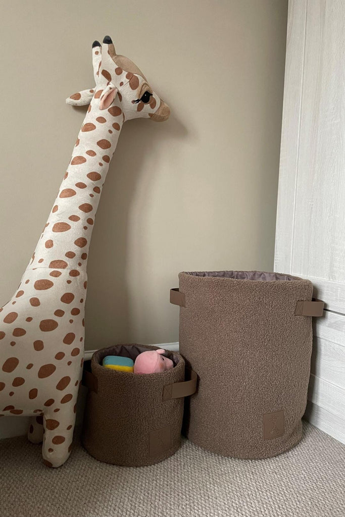 Set of two brown teddy fleece storage baskets in a nursery