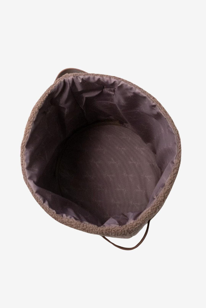 Top down view teddy storage basket with giraffe lining and side handles 