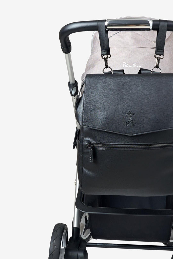 Black vegan leather changing backpack clipped to pram with matching pram clips