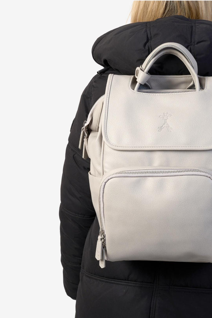 Mum wearing the grey vegan leather backpack with top handles and zipped front pocket 