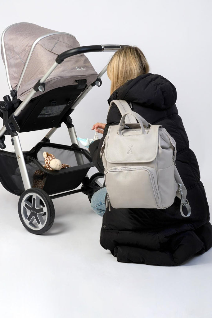 Mum wearing grey vegan leather baby changing backpack 